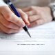 Woman signing a legal will document