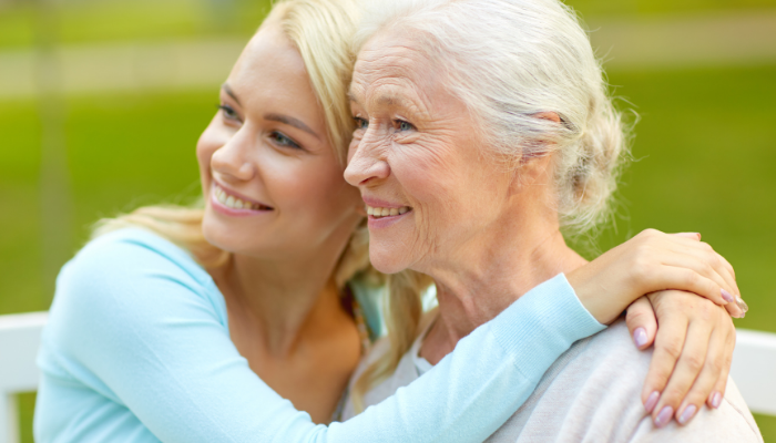 A senior woman with her adult daughter