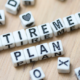 Letters spelling out the word "Retirement Planning" laid out on a table top